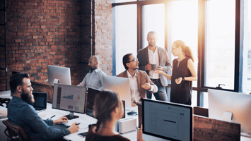 Modern office with professionals collaborating on workforce planning and skilled visa needs