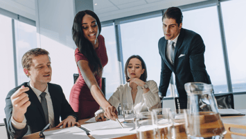 Diverse business team reviewing sponsorship agreement details in a boardroom setting