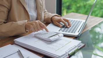 Employer calculating visa sponsorship costs and compliance documentation