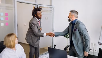 Business professionals shaking hands to represent growing employer sponsorship opportunities in Australia