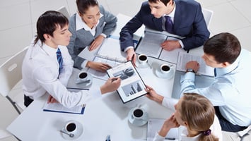 Corporate team discussing workforce planning and skilled migration strategies in business meeting