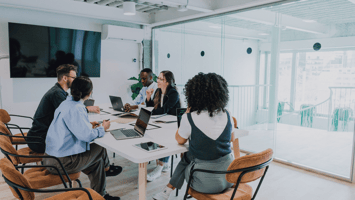 Diverse business team in a modern office discussing employer sponsorship strategies in Australia