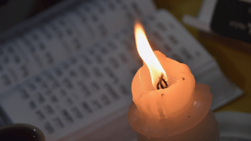 A candle in front of a bible