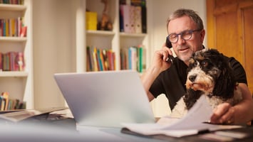 Small business owner managing operations and documents while working from home office